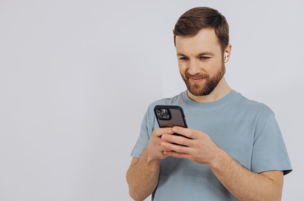 Portrait of a modern millennial man with a beard holding a smart, a Technology Photo by Cherkas Photography