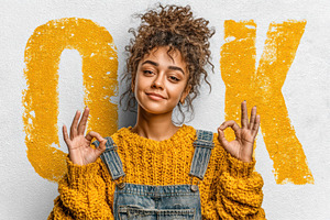 Confident young woman with curly hair in yellow knit sweater and, a Person Photo by José Manuel Gelpi
