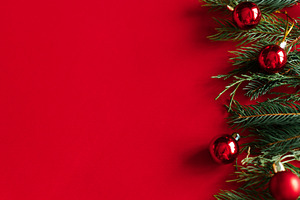 Christmas flat lay. Evergreen fir branches and shiny red baubles, a Photo by Sonjachni
