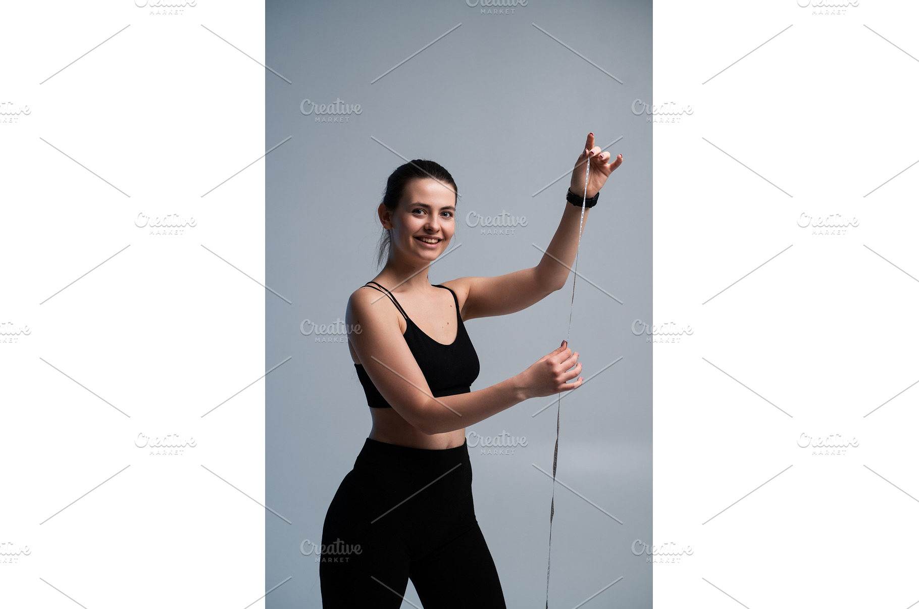 Young woman smiling, holding a, a Sports & Recreation Photo by volodymyrshtun13795