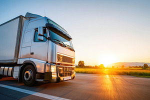 Truck driving on a scenic highway, a Transportation Photo by AlyaAnd