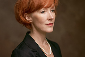 Mature redhead woman wearing a pearl necklace and black blazer,, a Person Photo by Studio ANNA