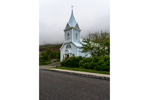 Famous Blue church surrounded by low, a Nature Photo by Backyard Stock