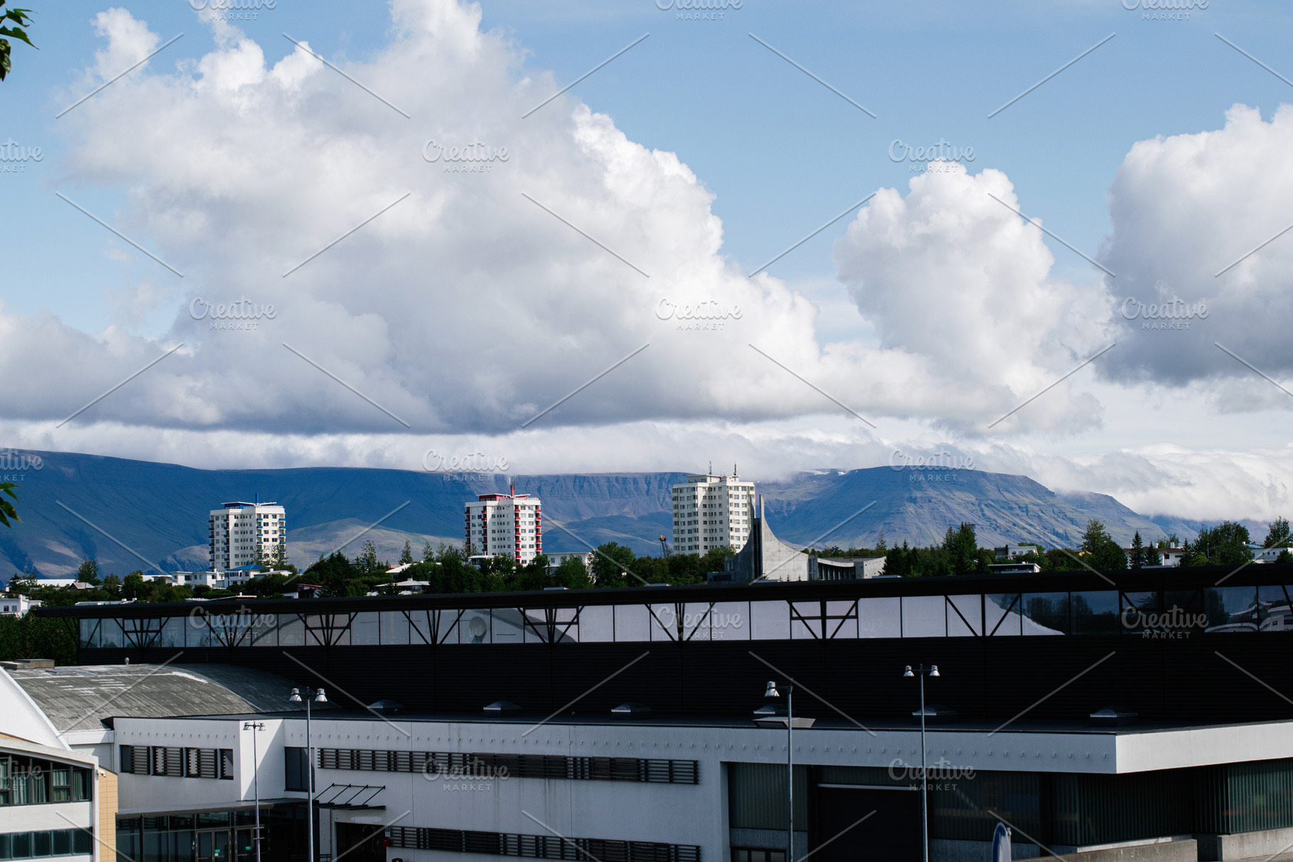 Scenic view of Reykjavik, Iceland architecture with mountains and clouds in bac, a Photo by AS photostudio