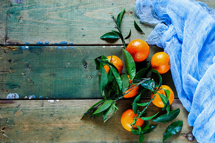 Tangerines green leaves stock photo containing foods and leaves, a Food & Drink Photo by Yuliya Gontar