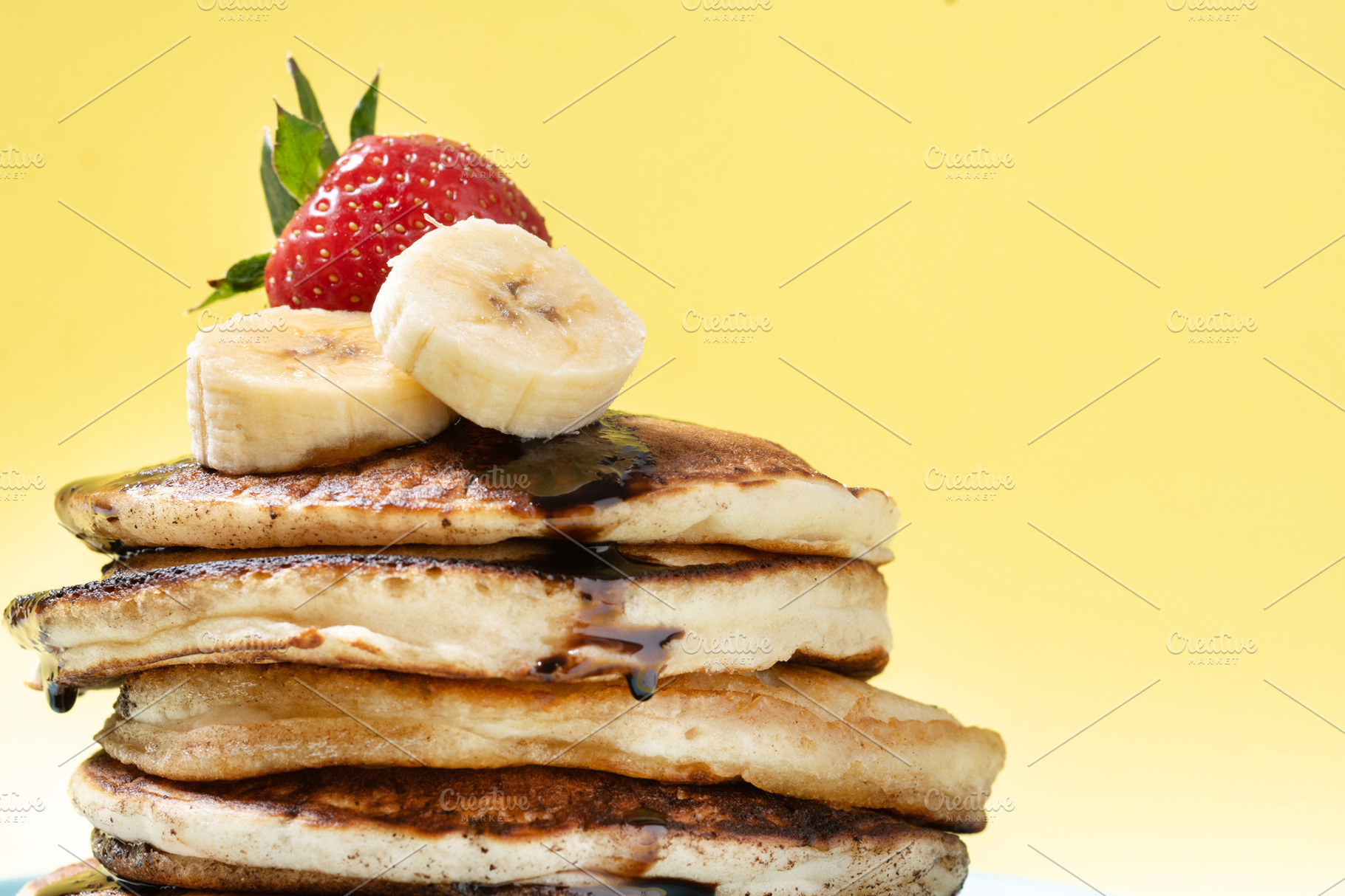 Pancakes with chocolate and fruit on yellow background, a Food & Drink Photo by etorres69