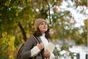 Female university student walking, a School & Education Photo by HalfPoint