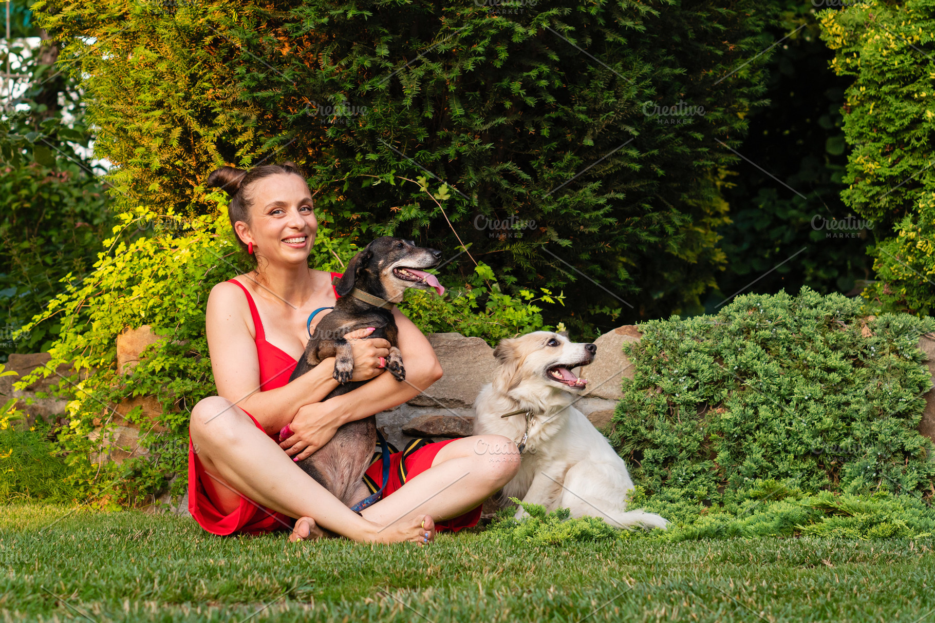 Woman in red dress sitting with two, an Animal Photo by Elena Vagengeim