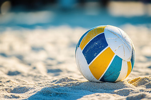 A bright volleyball sits on the soft, golden sand at a beach with a clear blue, a Sports & Recreation Photo by AlyaAnd