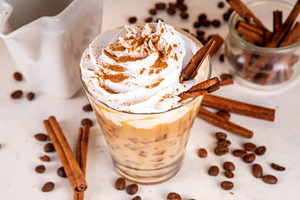 Iced cinnamon latte with whipped cream, a Food & Drink Photo by Rimma