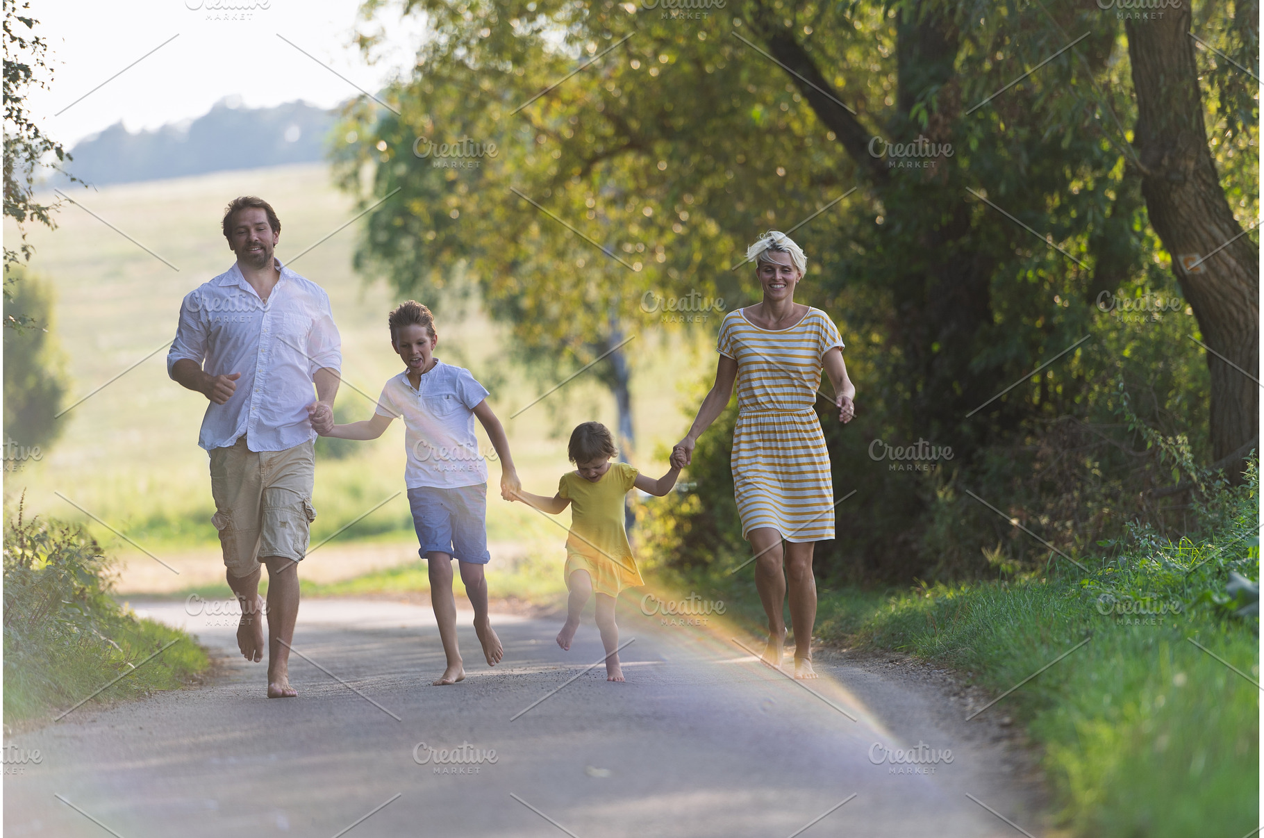 A family with small children running, a Person Photo by HalfPoint