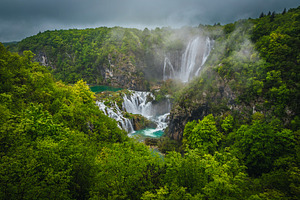 High waterfalls in the green forest, a Nature Photo by Alpine Dreams