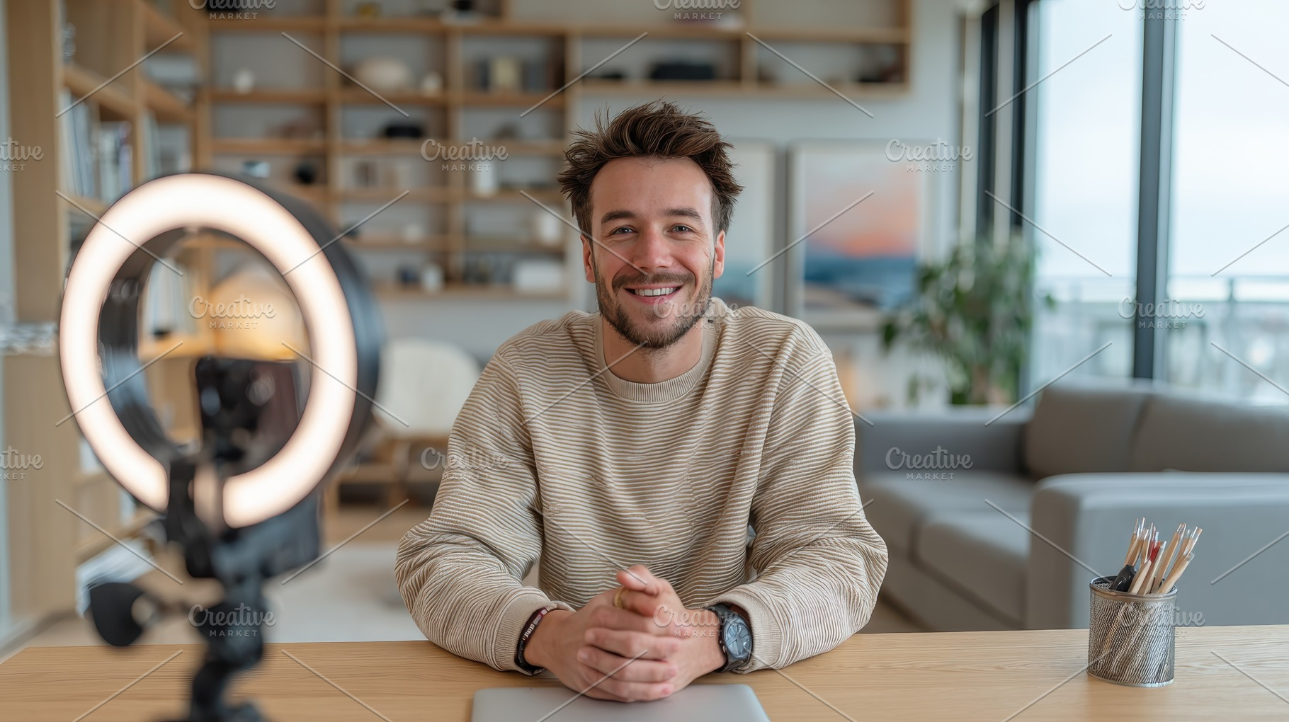 Smiling man vlogging in his home off, a Photo by Pixeness Studio