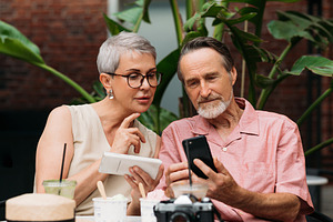 Mature couple using their smartphone, a Person Photo by Artem Varnitsin