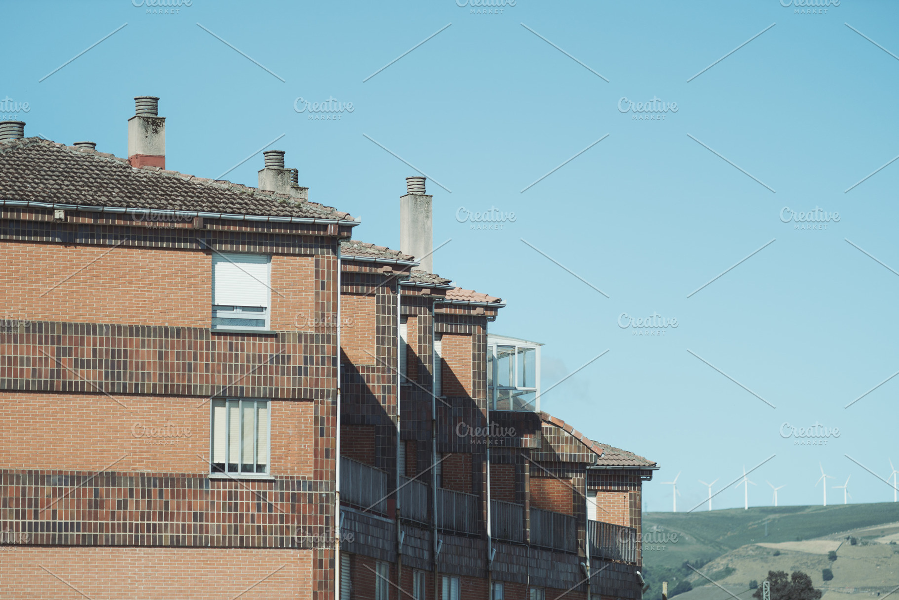 Brick buildings with wind turbines view, an Architecture Photo by SkyNext