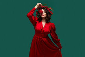 Playful woman holding Christmas ball, a Holiday Photo by Elena Vagengeim