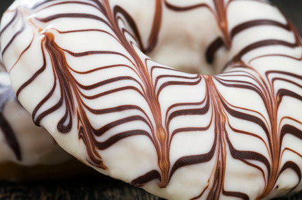 a fresh doughnut covered with white chocolate , closeup, a Food & Drink Photo by MyPhotos