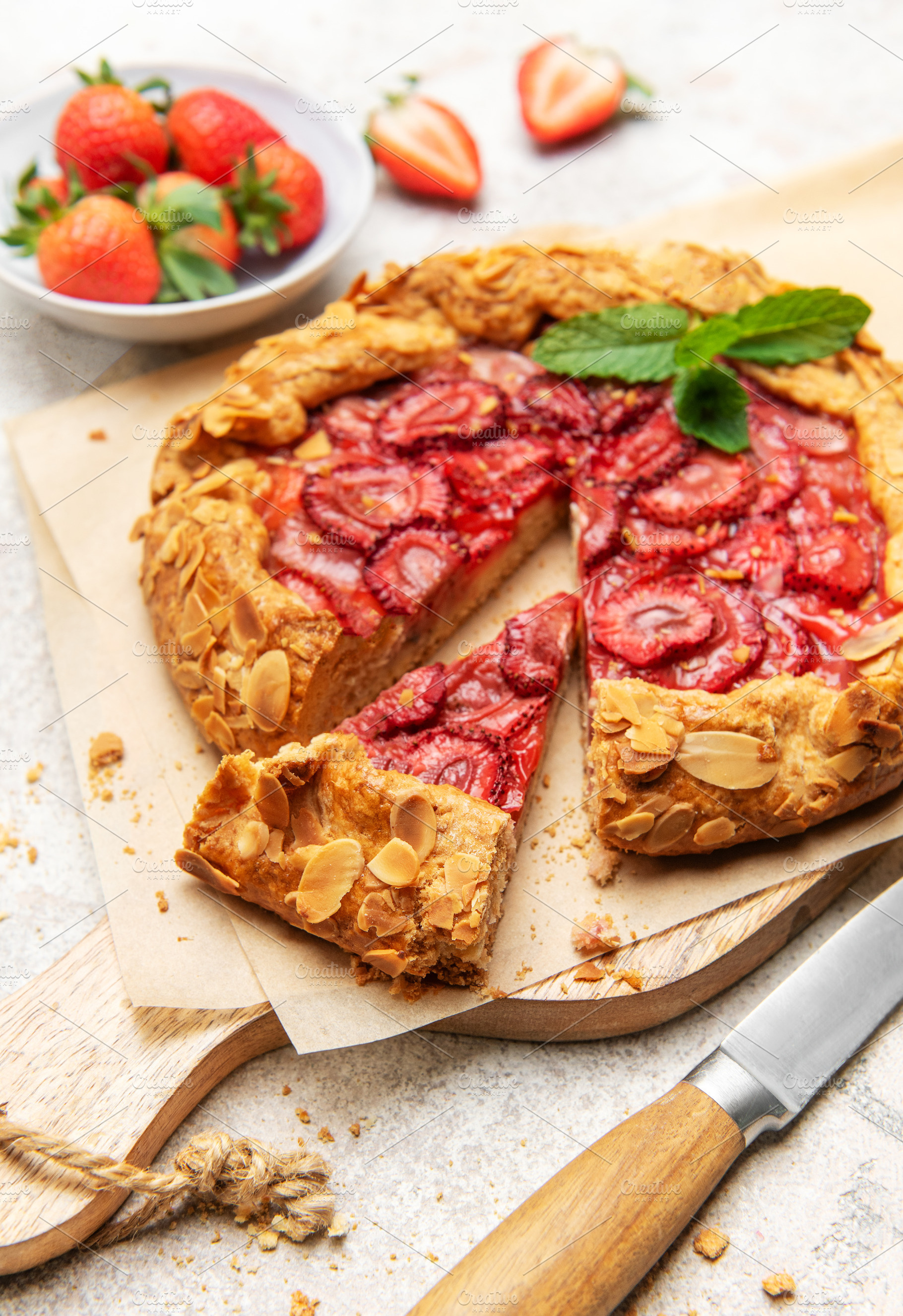 Delicious homemade strawberry galette with almond flakes and fre, a Food & Drink Photo by Olena Rudo