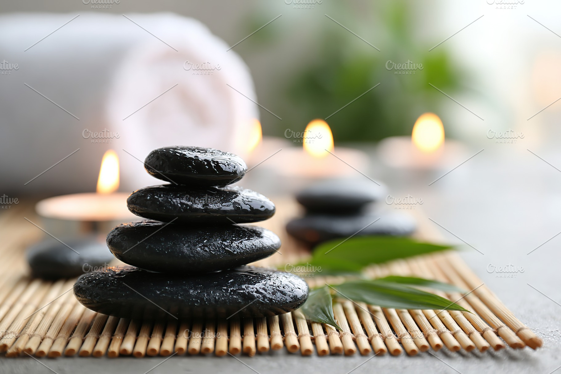 Smooth black basalt stones arranged in a tranquil spa setting for relaxation an, a Photo by AlyaAnd