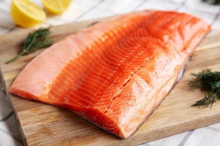 Organic Raw Salmon Fillet on a wooden board, side view., a Food & Drink Photo by LiudmylaChuhunova