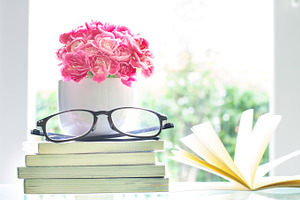 Pink carnation flower with books