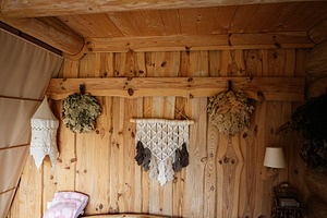 Rustic wooden interior with decorative hanging crafts and wooden furniture, a Photo by AS photostudio