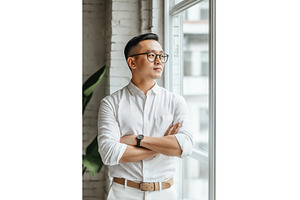 Asian businessman in a white shirt, a Person Photo by Sergey Kotenev