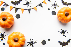 Halloween pumpkins with spiders bats and festive decorations