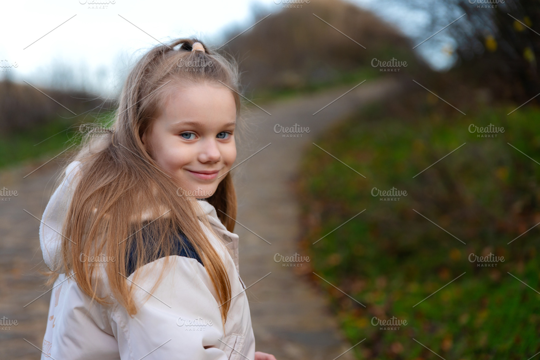 Portrait of a cheerful young girl walking on a path in nature, w, a Person Photo by Ales Munt