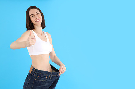 Concept of weight loss with thin girl on blue background, a Person Photo by AtlasStudio PRO