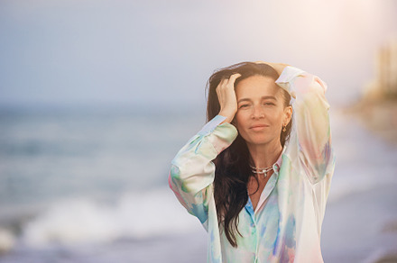 Young happy woman on the beach enjoy her summer vacation. Woman relax on the se, a Person Photo by travnikovstudio