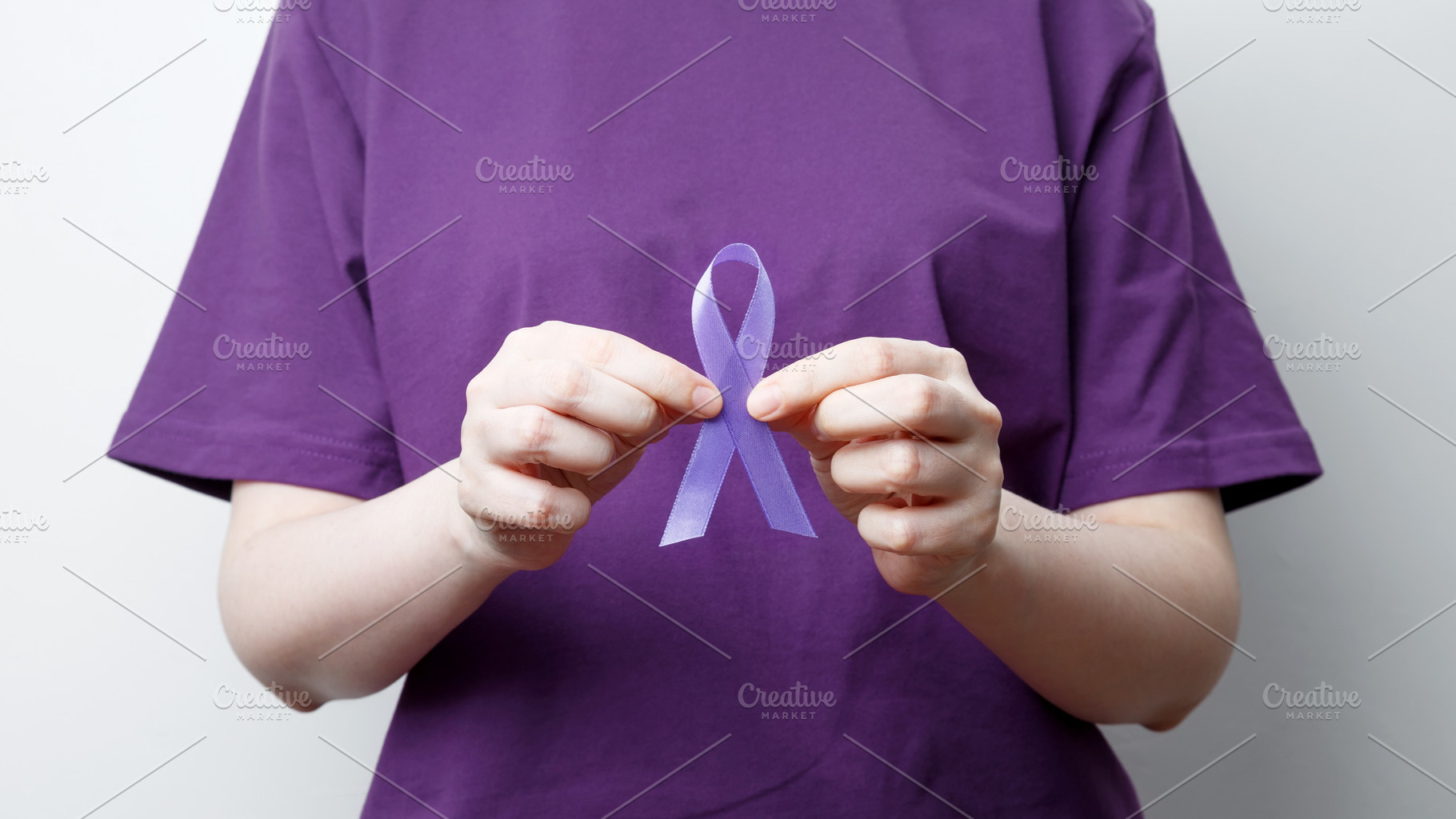 Purple ribbon held by a person in a purple shirt, symbol of support. Purple Epi, a Photo by matucha