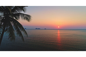 Tropical sunset over calm sea with