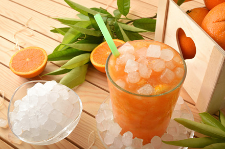 Detail of natural iced orange drink on wooden table, a Food & Drink Photo by Davizro's Market