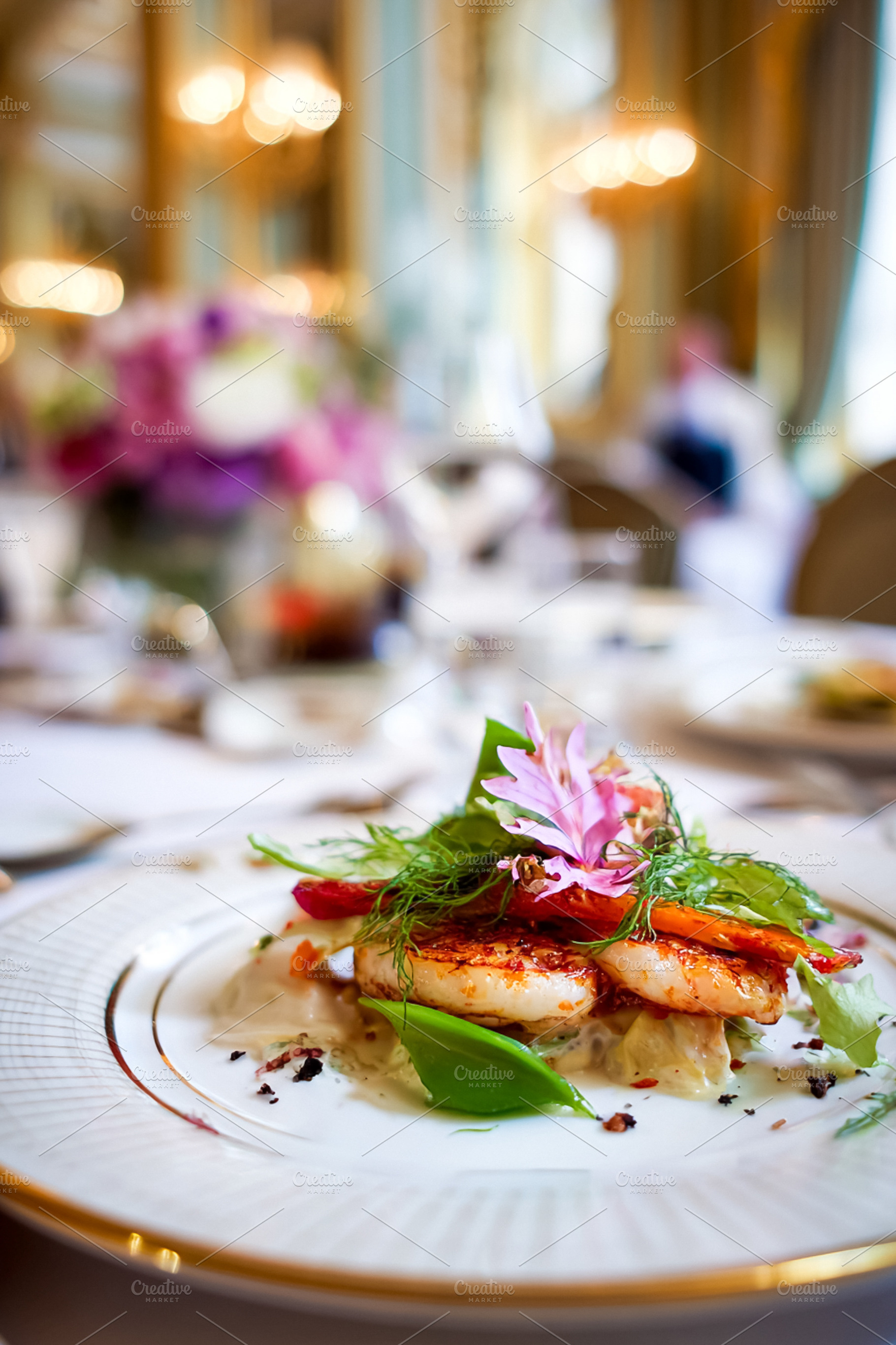 Pan seared scallops plated with fresh herbs and edible flowers,, a Food & Drink Photo by Studio ANNA