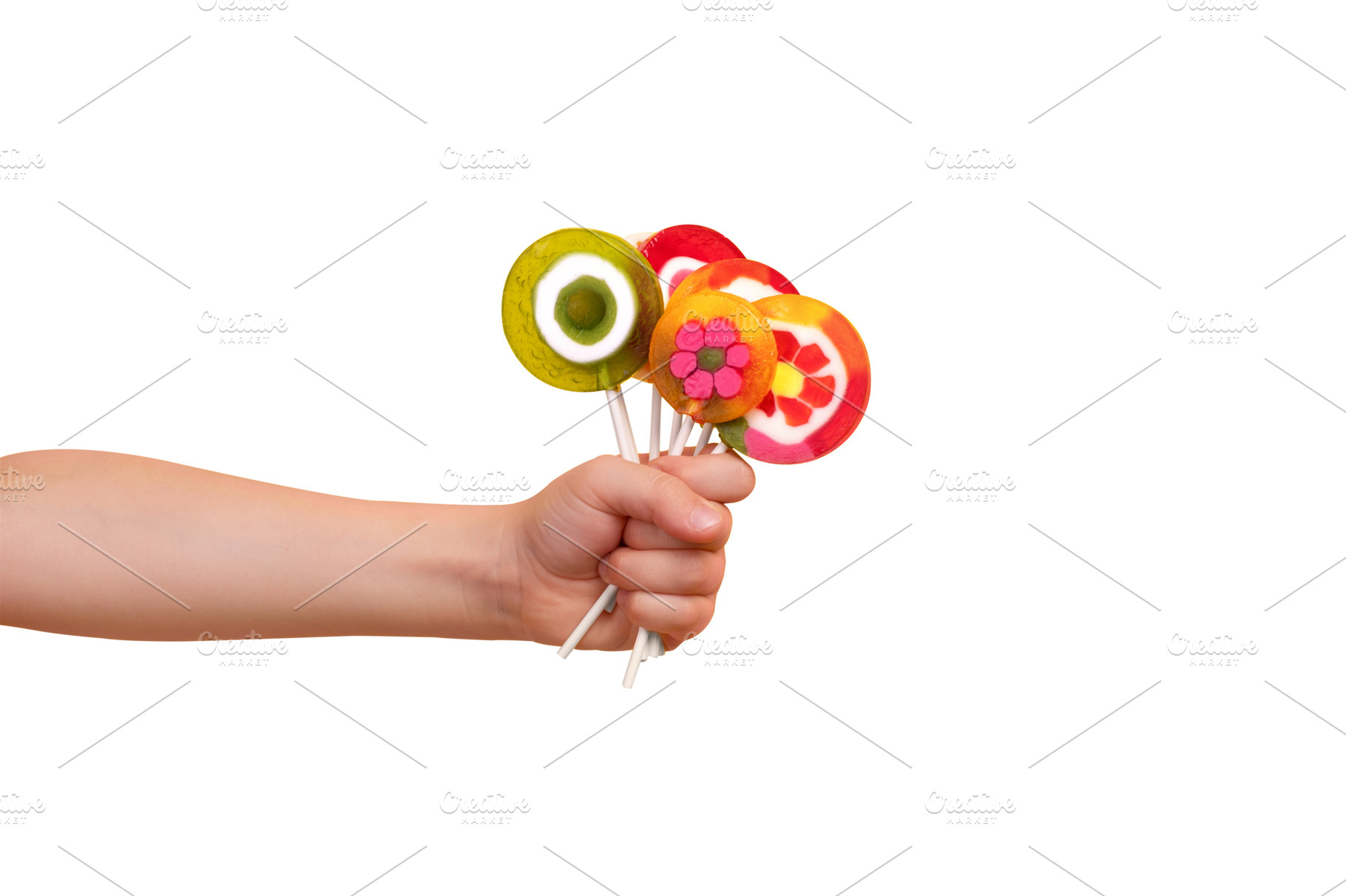Close-up of a child's hand holding assorted colorful round lolli, a Food & Drink Photo by Ales Munt