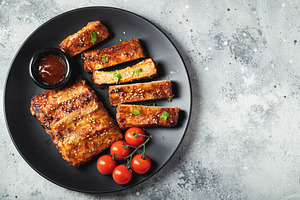 Closeup of pork ribs grilled with BBQ sauce and caramelized in honey., a Food & Drink Photo by Budarinphoto