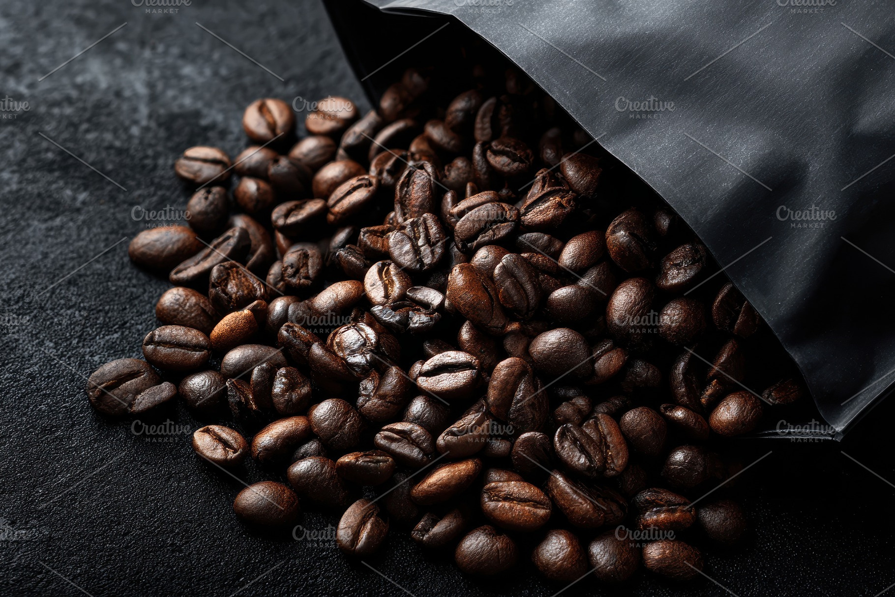 Coffee beans tumble out of a black, a Photo by Pavel_design