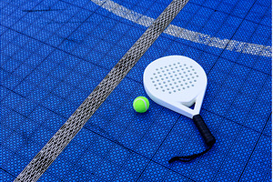 A padel racket and ball. on blue, a Sports & Recreation Photo by Yulia Furman
