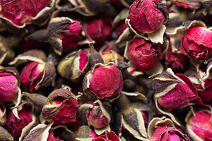 Dried rose buds creating fragrant herbal tea concept, a Food & Drink Photo by Olena Rudo