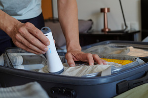 packing a suitcase with vacuum storage bags, a Photo by Nito