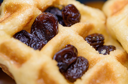 Close up fresh waffles with above dried raisins