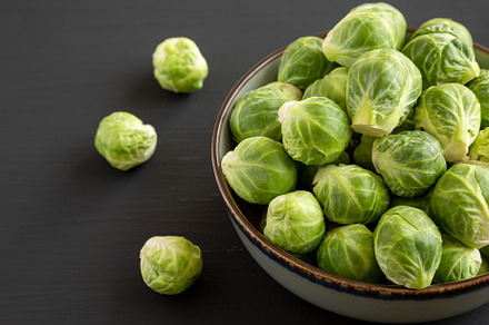 Raw Organic Brussel Sprouts in a Bowl on a black background, sid, a Food & Drink Photo by LiudmylaChuhunova