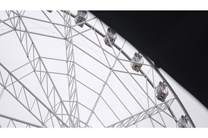Ferris wheel rotating under cloudy, a Sports & Recreation Photo by Media Whale Stock