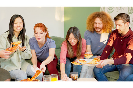 Friends smiling eating pizza, a Person Photo by Iván Moreno STOCK PHOTO