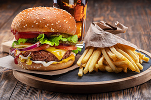 Tasty cheeseburger, glass of cola, a Food & Drink Photo by Volff