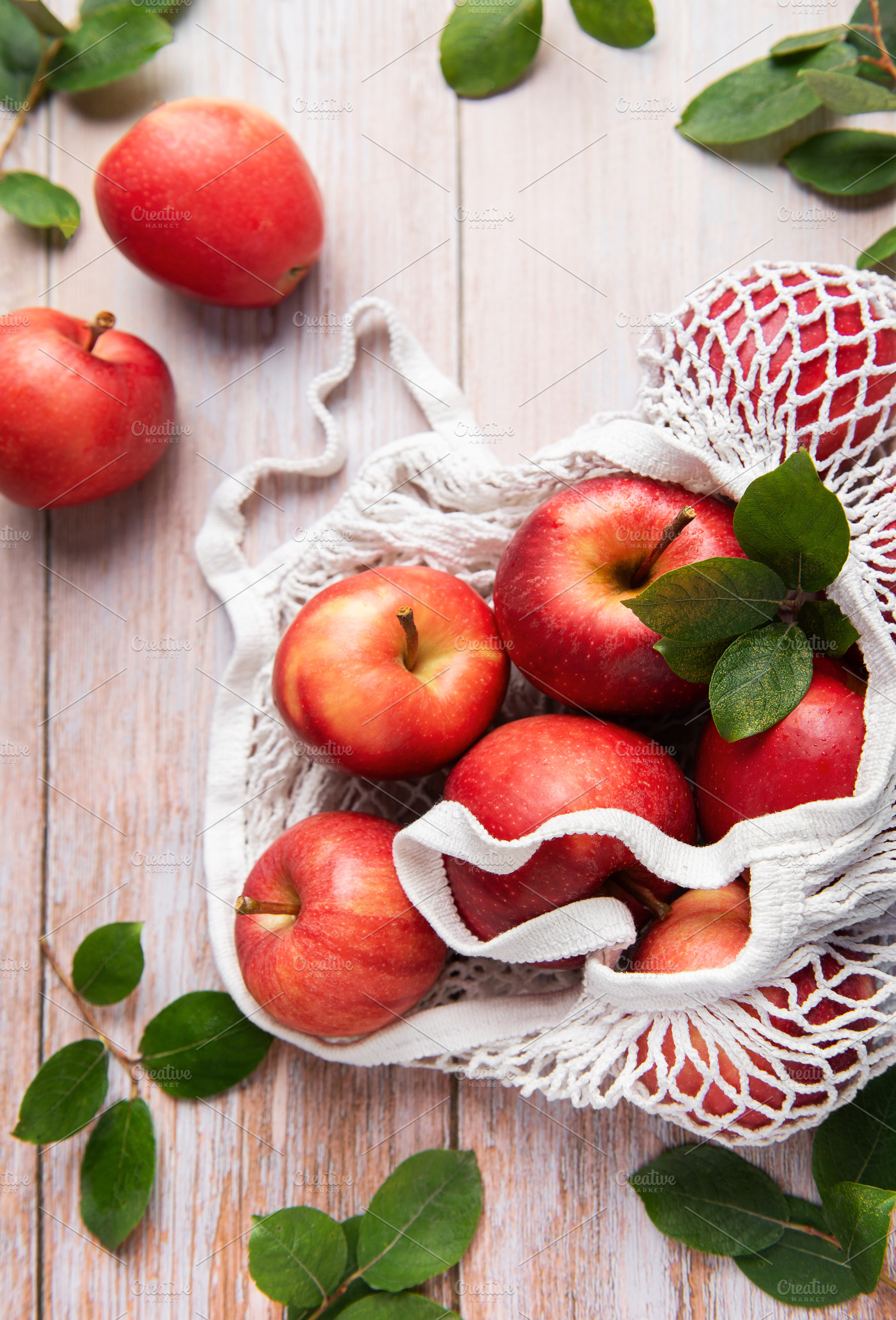 Fresh red apples in reusable shopping bag promoting sustainable, a Food & Drink Photo by Olena Rudo