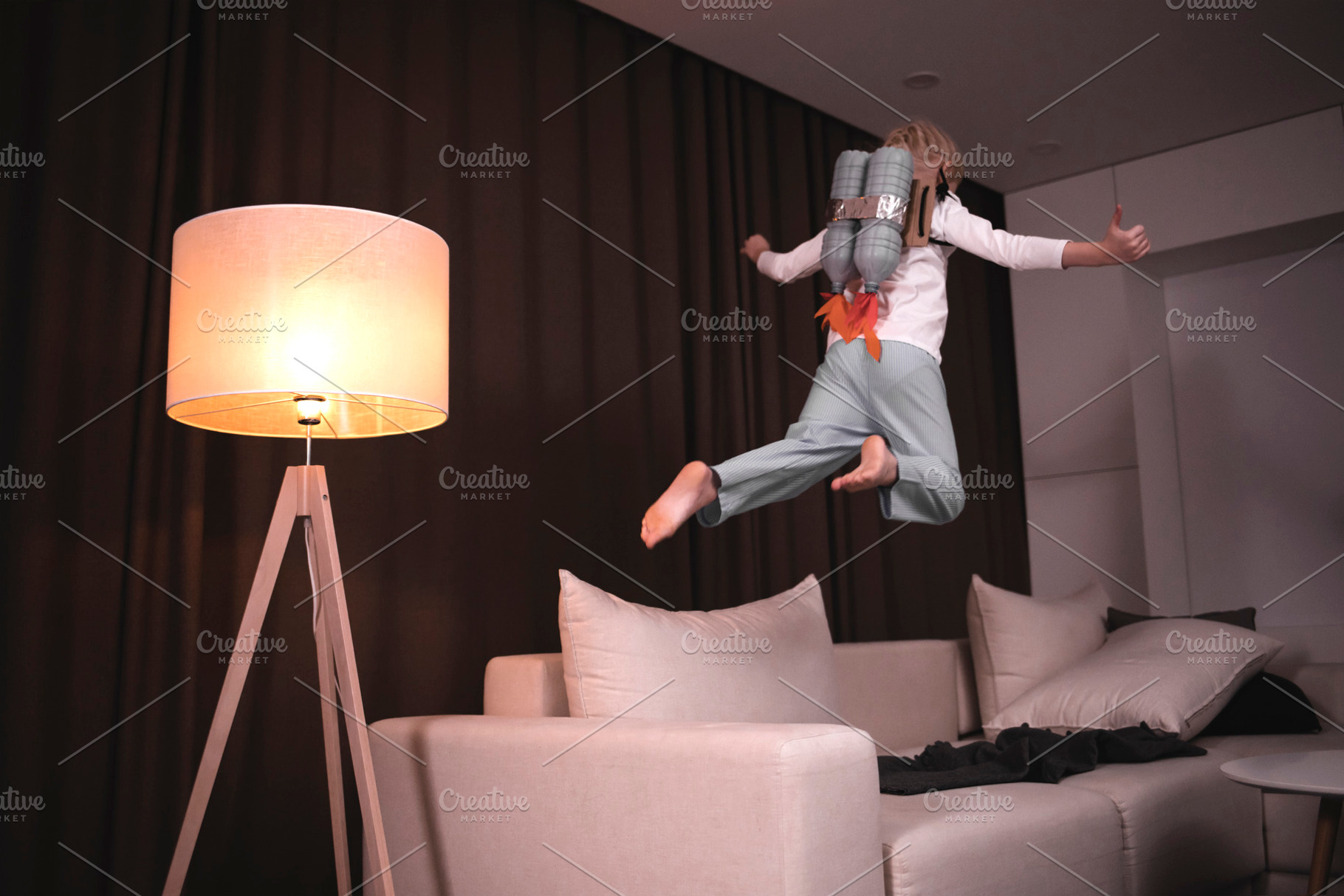 From sofa into open space containing girl, cute, and little, a Person Photo by supamotion