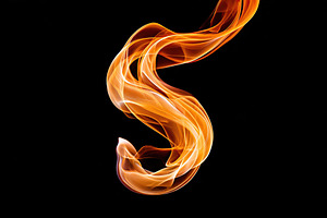 Elegant flame shape dancing gracefully against a dark background, an Arts & Entertainment Photo by AlyaAnd