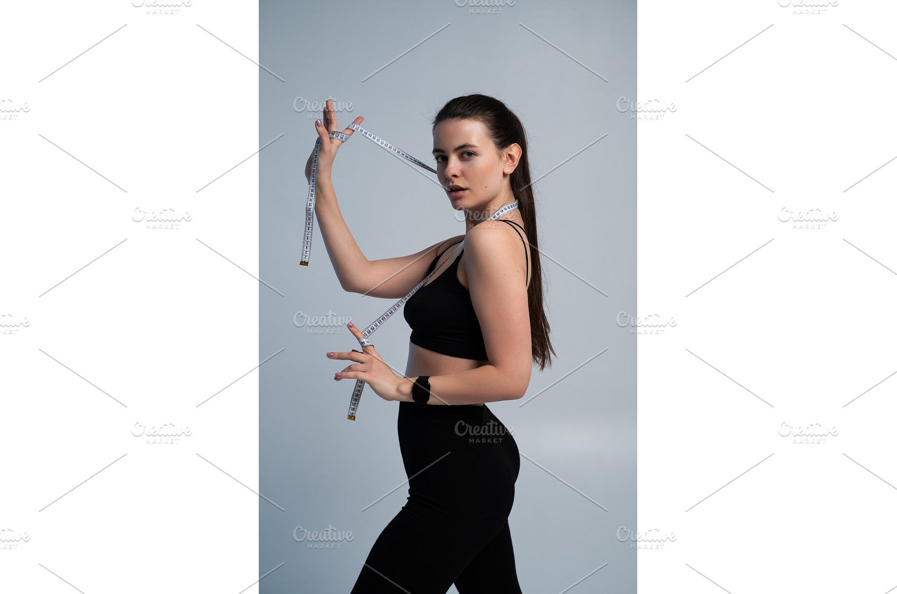 Young woman measuring her body with, a Sports & Recreation Photo by volodymyrshtun13795